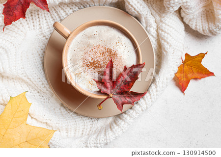 Autumn latte coffee with maple leaves and cozy plaid 130914500