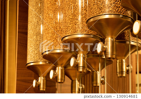 Decorative glass containers with taps for coffee beans in a coffee shop, selective focus. 130914681
