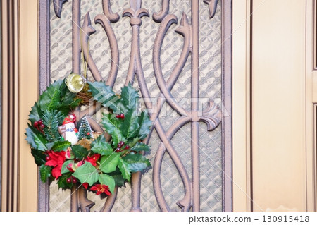 Christmas wreath hanging on the front door Christmas wreath hanging on the front door 130915418