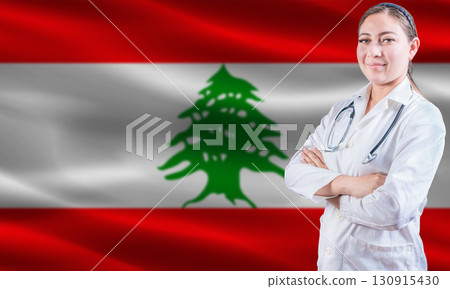 Female doctor on Lebanon flag. Doctor with crossed arms on Lebanon flag. Lebanon health and care concept Female doctor on Lebanon flag. Doctor with crossed arms on Lebanon flag. Lebanon health and care concept 130915430