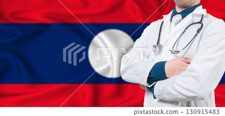 Laos healthcare concept. Male doctor on Laos flag. Doctor with crossed arms on Laos flag 130915483