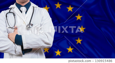 Male doctor with stethoscope on European Union flag. Doctor holding stethoscope on European Union flag 130915486