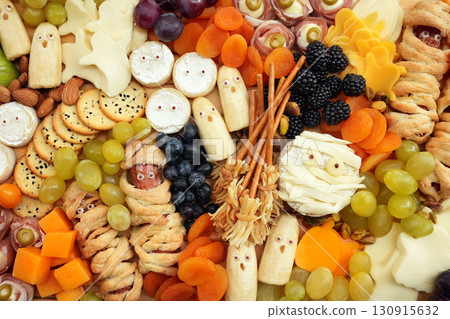 Healthy Halloween fun food mix: cheese ghosts and mummies, banana ghosts and grapes, blueberries and blackberries. Party spooky snacks for kids Healthy Halloween fun food mix: cheese ghosts and mummies, banana ghosts and grapes, blueberries and blackberries. Party spooky snacks for kids 130915632