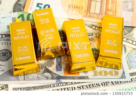 Gold bars on US dollar banknote money, finance trading investment business currency. 130915753