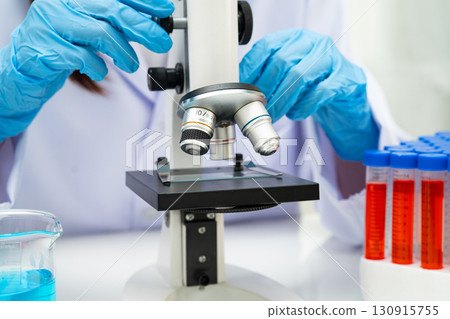 Scientist medical professional use microscope for research in science laboratory. 130915755