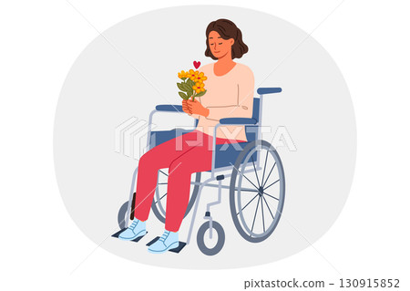 Woman sits in wheelchair holding bouquet of flowers in hands and rejoicing at receiving gift 130915852