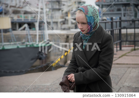 A woman in season coat on a cold day 130915864