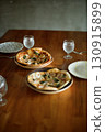 Homemade pizzas laid out on the table 130915899