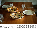 Homemade pizzas laid out on the table 130915968