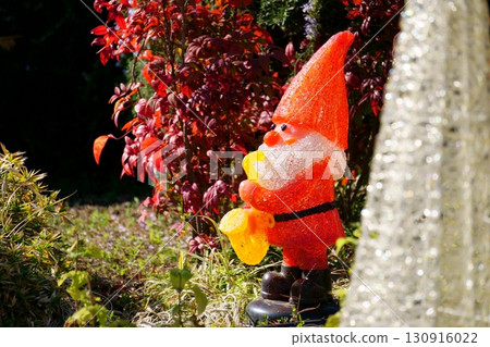 Santa Claus figurine displayed in a flower bed 130916022