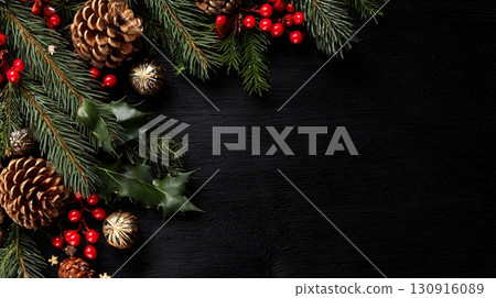 Christmas background features green pine branches, pinecones, red berries, gold ornaments on a dark wood surface. 130916089