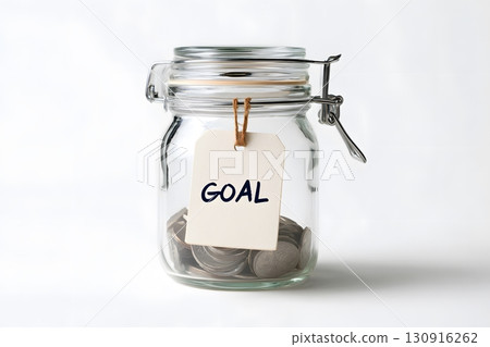 Glass jar holds money for a goal. 130916262