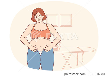 Woman experiencing problems with excess weight tries to put on small pants, and needs diet or fitnes Woman experiencing problems with excess weight tries to put on small pants, and needs diet or fitnes 130916381