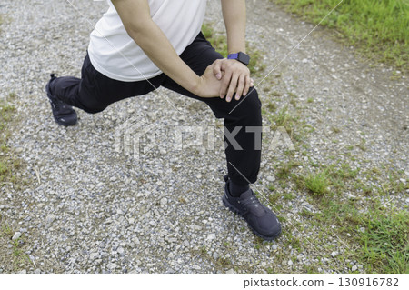 Young man stretching in the park Young man stretching in the park 130916782