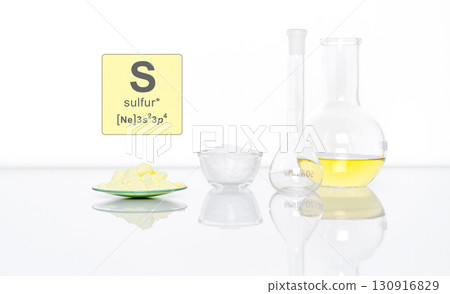 Sulfur Powder in Chemical Watch Glass with Symbol, Name and Electron Configuration on white laboratory table.  Side View 130916829