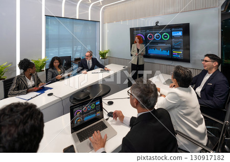 Business presentation in modern conference room showcasing data analysis and strategic planning with engaged audience participation. 130917182