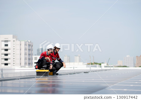 Team engineer and technician working on solar panel installation at rooftop, renewable energy. 130917442