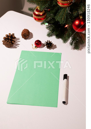 Making Festive Christmas and New Year Plans on White Table With Decorations Making Festive Christmas and New Year Plans on White Table With Decorations 130918246