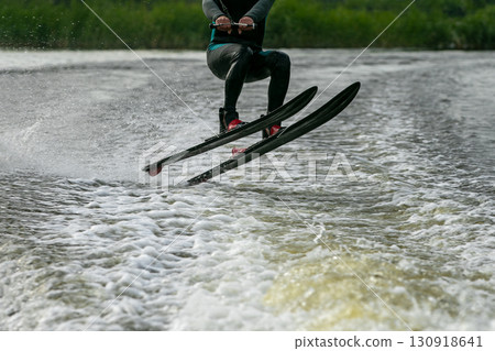 man jumped and flight on water ski over waves of lake man jumped and flight on water ski over waves of lake 130918641