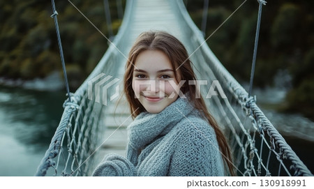 Girl smiling on a suspension bridge. Girl smiling on a suspension bridge. 130918991