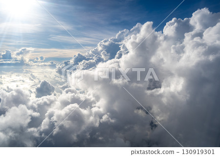 Majestic white clouds and deep blue sky seen from an airplane Majestic white clouds and deep blue sky seen from an airplane 130919301