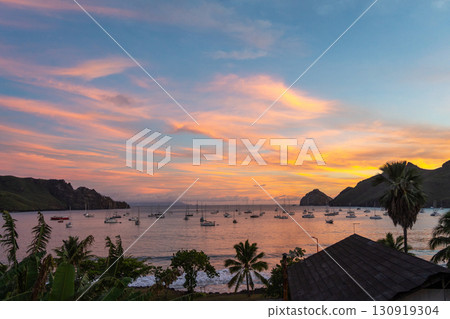 Taiohae Bay at sunset with sailboats in Nuku Hiva, Marquesas Islands, French Polynesia Taiohae Bay at sunset with sailboats in Nuku Hiva, Marquesas Islands, French Polynesia 130919304