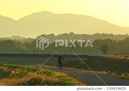 People walking along the river in the autumn colors People walking along the river in the autumn colors 130919626