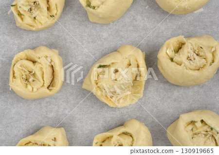 Unbaked rolls with garlic and parmesan 130919665