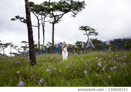 woman walks on a meadow and enjoys nature, Pine tree forest at Phu Soi Dao, Phu Soi Dao National Park, Uttaradit, Thailand woman walks on a meadow and enjoys nature, Pine tree forest at Phu Soi Dao, Phu Soi Dao National Park, Uttaradit, Thailand 130920251