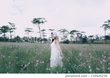 woman walks on a meadow and enjoys nature, Pine tree forest at Phu Soi Dao, Phu Soi Dao National Park, Uttaradit, Thailand 130920256