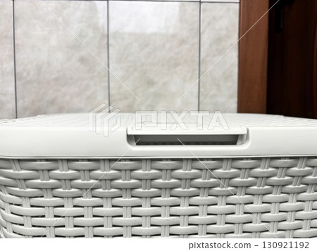 Laundry basket standing in bathroom interior. Household chores, laundry storage, washing and hygiene concept 130921192