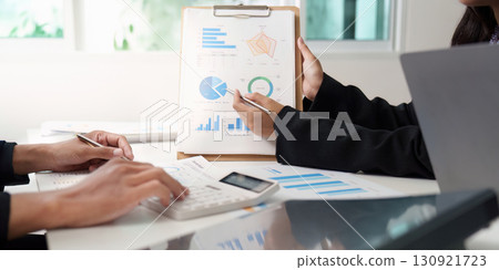 Data Presentation. Colleagues reviewing financial charts and calculations. 130921723