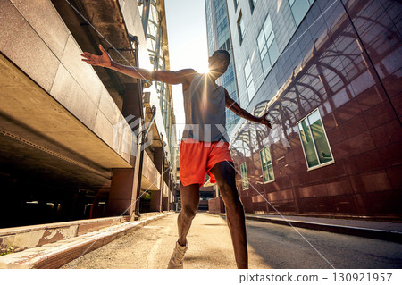 Athletic man jogging in an urban area during a sunny day Athletic man jogging in an urban area during a sunny day 130921957