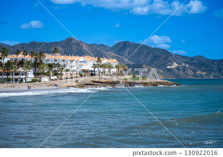 NERJA, SPAIN - MARCH 22, 2025: Wonderful landscapes of the shimmering sea and charming city unfold, offering breathtaking coastal views and a picturesque atmosphere in Nerja, Spain on March 22, 2025 130922016