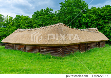 A typical Ukrainian ancient house covered with straw stands quietly, reflecting traditional rural architecture and cultural heritage in Ukraine. A typical Ukrainian ancient house covered with straw stands quietly, reflecting traditional rural architecture and cultural heritage in Ukraine. 130922163