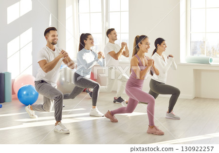 Team Of Athletes Doing Squats In The Gym Team Of Athletes Doing Squats In The Gym 130922257