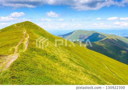 path for mountain tourism in summer. alpine landscape of ukraine. beautiful scenery of borzhava ridge with green hills under blue sky with clouds path for mountain tourism in summer. alpine landscape of ukraine. beautiful scenery of borzhava ridge with green hills under blue sky with clouds 130922300