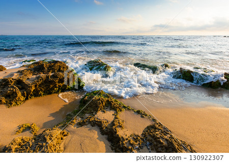 beach with sand in morning light. summer vacation at the seaside of bulgaria. beautiful seascape with calm waves. landscape at the sea under sky with fluffy clouds beach with sand in morning light. summer vacation at the seaside of bulgaria. beautiful seascape with calm waves. landscape at the sea under sky with fluffy clouds 130922307