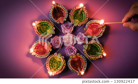 Sparkling Diwali candles with flower petals 130922417
