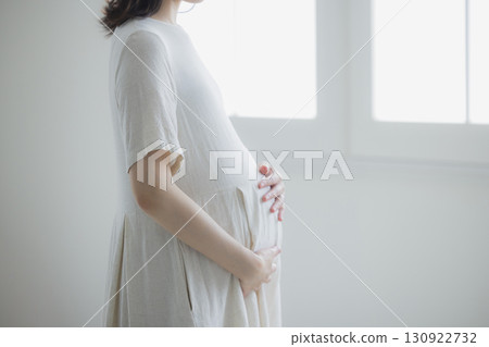 pregnant woman in the living room pregnant woman in the living room 130922732