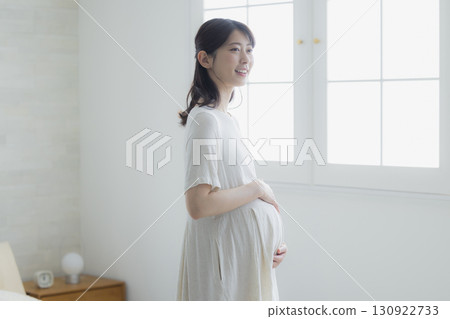 pregnant woman in the living room pregnant woman in the living room 130922733