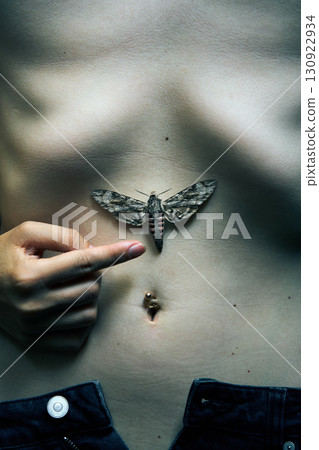 Butterfly sitting on woman belly. 130922934