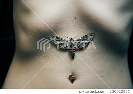 Butterfly sitting on woman belly. 130922935