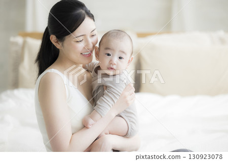 Mother holding a baby 130923078
