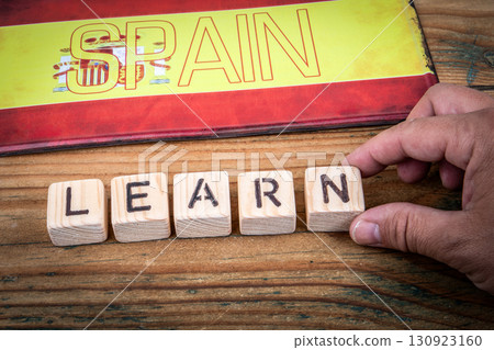Learning Spanish language concept with wooden letter blocks and Spain flag 130923160