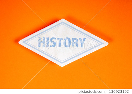 History concept on white label against orange background with bold blue typography History concept on white label against orange background with bold blue typography 130923192