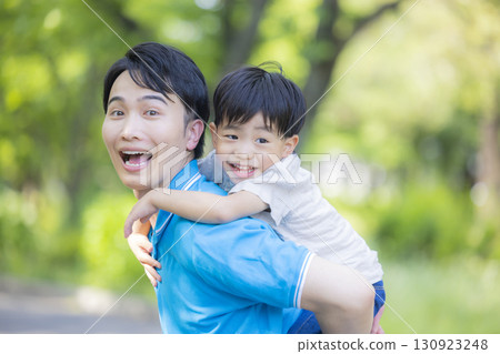 Parent and child playing in the park 130923248