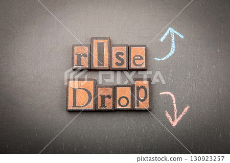 Rise and drop concept with wooden blocks and arrows 130923257
