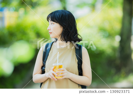 A woman walking in green A woman walking in green 130923371