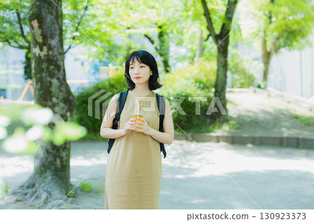 A woman walking in green A woman walking in green 130923373